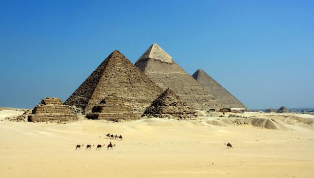 The iconic Egypt Pyramids standing tall against a clear blue sky, showcasing ancient architectural marvels