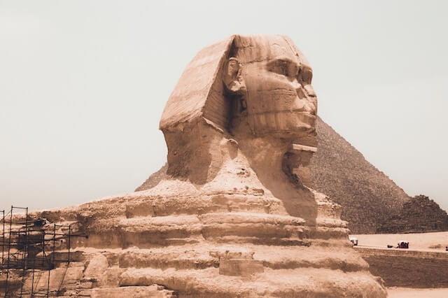 The enigmatic Sphinx, a mythical creature with the body of a lion and the head of a human, guarding the entrance to the Egypt Pyramids.